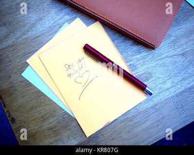 Photo of See You Tonight message written on a colored paper Stock Photo