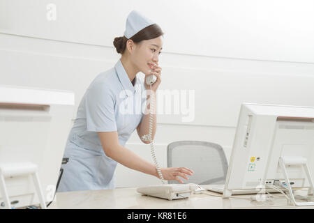 The young woman nurse is on the phone Stock Photo