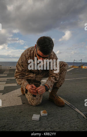 MEDITERRANEAN SEA (Dec. 10, 2017) – Staff Sgt. Charles Bourne, assigned to the 15th Marine Expeditionary Unit’s (MEU) Combat Cargo, loads a pistol magazine during a small arms gun shoot aboard the San Antonio-class amphibious transport dock ship USS San Diego (LPD 22), Dec. 10, 2017. Pistol training ensures Marines and Sailors stay proficient and ready as a crisis-contingency force. San Diego is deployed with the America Amphibious Ready Group and 15th MEU to support maritime security operations and theater security cooperation efforts in the U.S. 6th Fleet area of operations. (U.S. Marine Cor Stock Photo