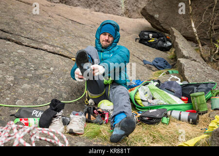 A man puts his climbing shoes on Stock Photo