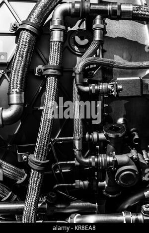 Fragment of modern technology. Details of engine pipelines. Black and white. Background. Stock Photo