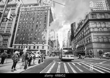 New York, USA - May 26, 2017: People wait to cross the street at 7th Avenue and West 57th Street intersection. Stock Photo