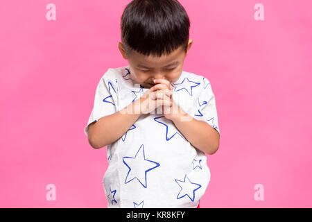 Asian little kid praying Stock Photo