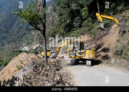 Sikkim, India. 18th Dec, 2017. Indian labor uses a caterpillar for road construction to expand roads at East Sikkim near old silk route on December 18, 2018 in Padamechen, India. The famous silk route connected Lhasa (Tibet) to Kalimpong used few decades ago until the Chinese in invasion of Tibet. Credit: Saikat Paul/Pacific Press/Alamy Live News Stock Photo