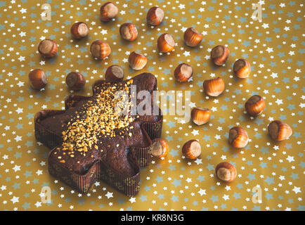 Sweet Christmas tree with forest nuts on the brown background Stock Photo