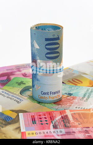 banknotes of 100 swiss franc rolled with rubber Stock Photo