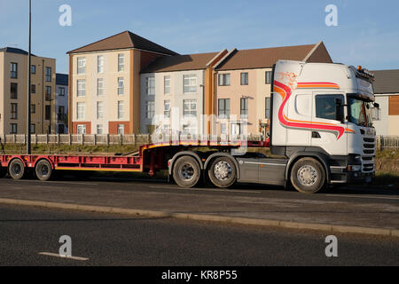 December 2017 -  Big truck passing a new housing estate near Filton, Bristol. Stock Photo