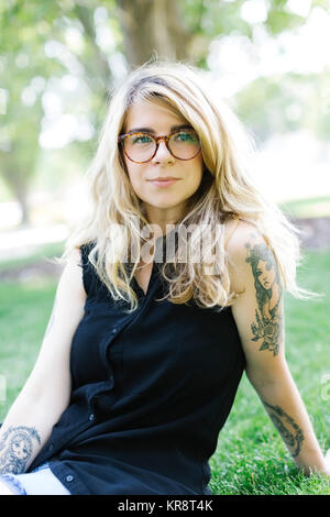 Portrait of woman sitting on grass Stock Photo