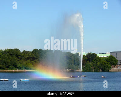 fountain with rainbow on the inner alster lake in hamburg Stock Photo