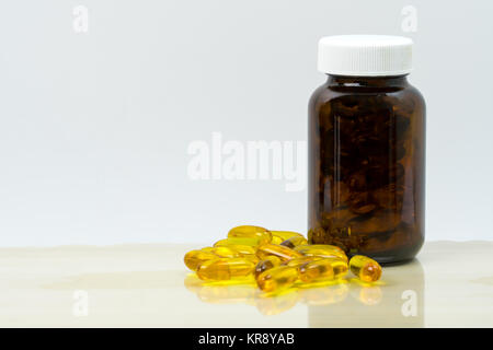 Download Yellow Fish Oil Capsule Pills With Amber Glass Bottle With Blank Stock Photo Alamy PSD Mockup Templates