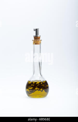 Thyme infused olive oil over white background Stock Photo