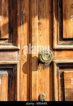 Closeup view of an old wooden door handle with flower details. Stock Photo
