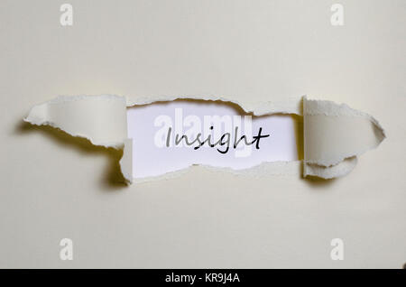 The word insight appearing behind torn paper Stock Photo