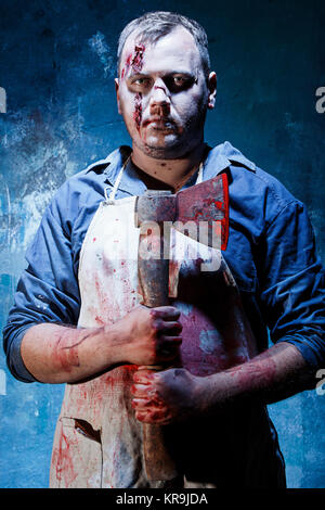 Bloody Halloween theme: crazy killer as butcher with an ax Stock Photo