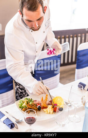 Chef decorating appetizer plate