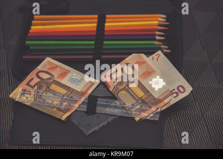 expensive school theme, pencil case with euro money Stock Photo