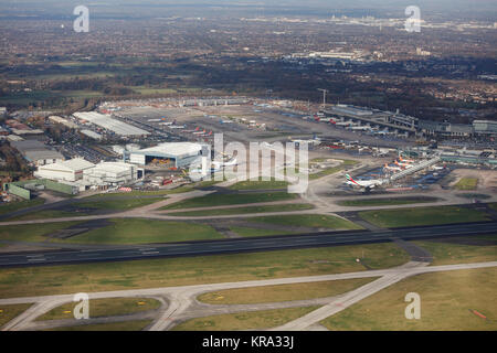 An aerial view showing hangars, the control tower, aprons and terminals of Manchester Airport. Stock Photo