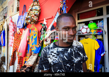 Man working in a shop in a backstreet of Santa Maria, selling souvenirs to tourists. Sal, Sal island, Cape Verde, Africa Stock Photo