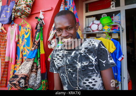 Man working in a shop selling souvenirs to tourists, Santa Maria, Sal, Salina, Cape Verde, Africa Stock Photo