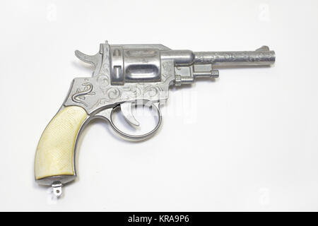 toy gun: revolver for firing percussion caps, ornamented, with white handle Stock Photo