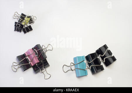stacks of metal binder clips for paper, different sizes and colors Stock Photo