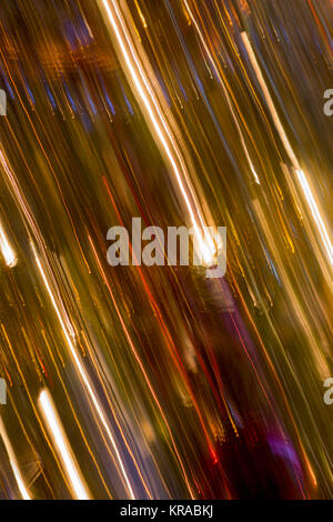 Alternating bright lines, colourful lines and golden lines - vertical panning of Christmas tree with baubles and lights Stock Photo