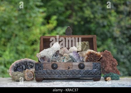 many minerals quartz and crystal stones in wooden box Stock Photo