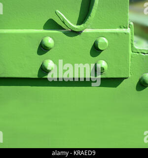 riveted steel plates with green paint Stock Photo