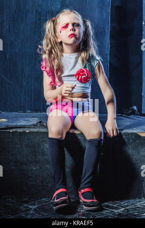 The crasy girl with candy on dark background Stock Photo