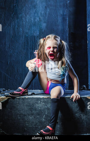 The crasy girl with candy on dark background Stock Photo