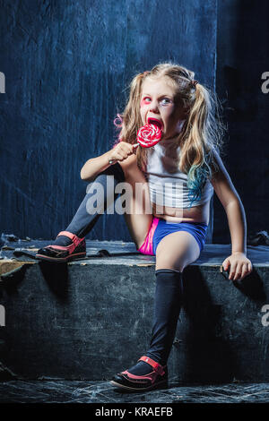 The funny crasy girl with candy on dark background Stock Photo