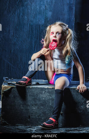 The funny crasy girl with candy on dark background Stock Photo