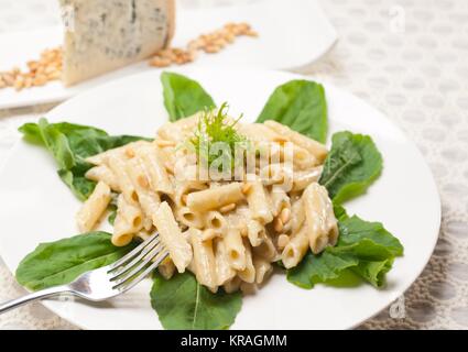 italian pasta penne gorgonzola and pine nuts Stock Photo