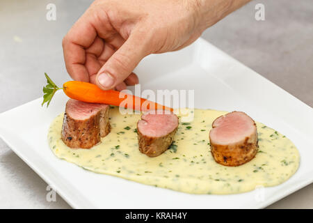 Chef garnishing dish Stock Photo