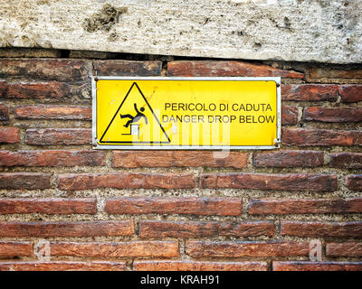 Danger sign on a brick wall Stock Photo