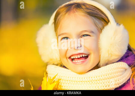 Happy little girl in earflaps Stock Photo