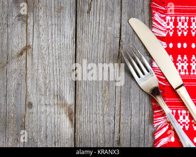 Fork and knife on kitchen towel Stock Photo