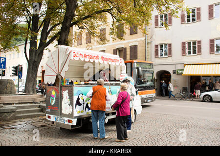 Italian people and foreigner travellers buying ice cream Italian style from food truck and travel street market at Meran city on September 2, 2017 in  Stock Photo