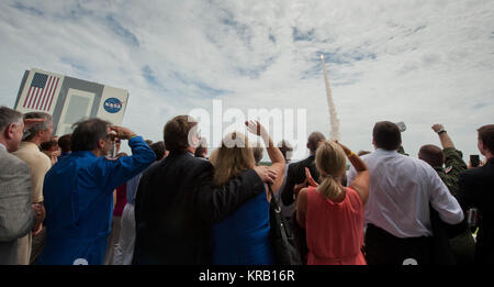 Guests look on from the terrace of Operations Support Building II as space shuttle Atlantis launches from launch pad 39A on the STS-135 mission Friday, July 8, 2011, at Kennedy Space Center in Cape Canaveral, Fla.  Atlantis and its crew will deliver to the International Space Station the Raffaello multipurpose logistics module containing supplies and spare parts for the space station.  Photo Credit: (NASA/Carla Cioffi) STS-135 launch viewing site Stock Photo