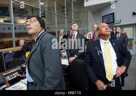 NASA Administrator Charles Bolden, right, Associate Administrator for Space Operations William Gerstenmaier, center, Associate Administrator Christopher Scolese, left, and other management look on from Firing Room Four of the Launch Control Center (LCC) as space shuttle Atlantis launches from pad 39A on Friday, July 8, 2011, in Cape Canaveral, Fla. The launch of Atlantis, STS-135, is the final flight of the shuttle program, a 12-day mission to the International Space Station.  Photo Credit: (NASA/Bill Ingalls) NASA officials watch the final mission of the Space Shuttle Stock Photo