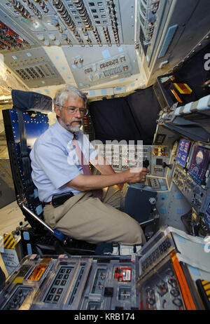 Dr. John Holdren, Director of the White House Office of Science and Technology Policy, and Co-Chair of the President’s Council of Advisors on Science and Technology, sits in the commander's chair aboard space shuttle Discovery at the Orbiter Processing Facility at NASA's Kennedy Space Center, Friday, July 8, 2011, in Cape Canaveral, Fla. Holdren was given a tour Discovery, which is in the process of decomissioning, following the launch of Atlantis (STS-135) Friday. Photo Credit: (NASA/Paul E. Alers) John Holdren sits in Space Shuttle Discovery soon to be decommissioned Stock Photo