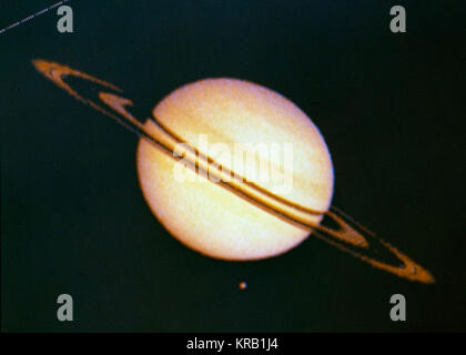Pioneer 11 Image of Saturn and Its Moon Titan Stock Photo