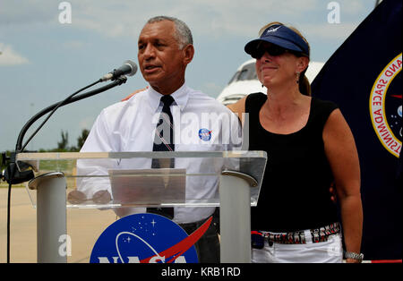 NASA administrator Charles Bolden along with Deputy Administrator Lori Garver addresses Kennedy Space Center employees and contractors as space shuttle Atlantis (STS-135) sits in the background near the Orbiter Processing Facility (OPF) at a wheels stop event, Thursday, July 21, 2011, in Cape Canaveral, Fla. Atlantis returned to Kennedy early Thursday following a 13-day mission to the International Space Station (ISS) and marking the end of the 30-year Space Shuttle Program. Overall, Atlantis spent 307 days in space and traveled nearly 126 million miles during its 33 flights. Atlantis, the fou Stock Photo