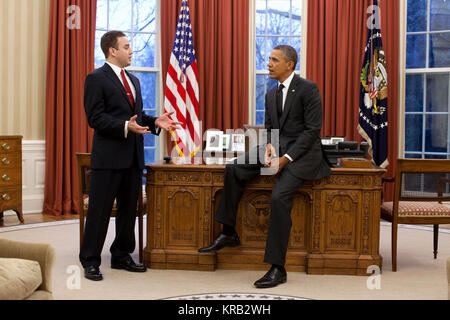 President Barack Obama talks with Matthew Ritsko, the winner of the 2011 Presidential Securing Americans' Value and Efficiency (SAVE) award, in the Oval Office, Jan. 9, 2012. Ritsko, a financial manager at NASA's Goddard Space Flight Center, proposed the space agency create a 'lending library' where specialized space tools and hardware purchased by one NASA organization will be made available to other NASA programs and projects. (Official White House Photo by Pete Souza) This official White House photograph is being made available only for publication by news organizations and/or for personal  Stock Photo