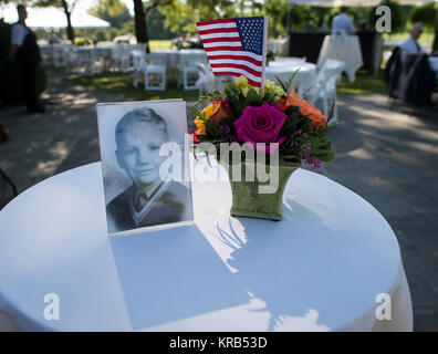 A photograph of Neil Armstrong as a young man is displayed on a table during a memorial service celebrating the life of Armstrong, Friday, Aug. 31, 2012, at the Camargo Club in Cincinnati. Armstrong, the first man to walk on the moon during the 1969 Apollo 11 mission, died Saturday, Aug. 25. He was 82. Photo Credit: (NASA/Bill Ingalls) Neil Armstrong family memorial service (201208310014HQ) Stock Photo