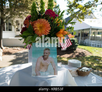 A photograph of Neil Armstrong as a young man is displayed on a table during a memorial service celebrating the life of Armstrong, Friday, Aug. 31, 2012, at the Camargo Club in Cincinnati. Armstrong, the first man to walk on the moon during the 1969 Apollo 11 mission, died Saturday, Aug. 25. He was 82. Photo Credit: (NASA/Bill Ingalls) Neil Armstrong family memorial service (201208310015HQ) Stock Photo