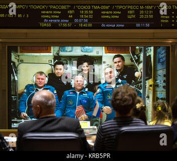 Family of the newly arrived International Station Expedition 33/34 crew members, Russian cosmonaut Oleg Novitskiy, front left, NASA astronaut Kevin Ford, front center, and Russian cosmonaut Evgeny Tarelkin, front right, talk via phone to the crew from the Russian Mission Control Center in Korolev, Russia shortly after the three joined Flight Engineer Aki Hoshide of the Japan Aerospace Exploration Agency, back left, Expedition 33 Commander Sunita Williams of NASA, back center, and Yuri Malenchenko of the Russian Federal Space Agency on Thursday, Oct. 25, 2012. Photo Credit: (NASA/Bill Ingalls)  Stock Photo