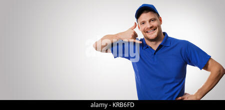 worker in blue uniform making phone call gesture Stock Photo