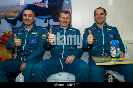 Expedition 34 Russian Flight Engineer Evgeny Tarelkin, left, Russian Soyuz Commander Oleg Novitskiy, center, and Flight Commander Kevin Ford of NASA sit together at the Kustanay Airport a few hours after they landed near the town of Arkalyk, Kazakhstan on Saturday, March 16, 2013. Ford, Novitskiy, and Tarelkin are returning from 142 days onboard the International Space Station where they served as members of the Expedition 33 and 34 crews. Photo Credit: (NASA/Bill Ingalls) Soyuz TMA-06M crew members sit together at the Kustanay Airport Stock Photo