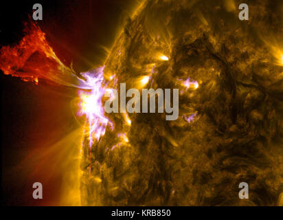 Caption: A burst of solar material leaps off the left side of the sun in what’s known as a prominence eruption.  This image combines three images from NASA’s Solar Dynamics Observatory captured on May 3, 2013, at 1:45 pm EDT, just as an M-class solar flare from the same region was subsiding. The images include light from the 131, 171 and 304 Angstrom wavelengths.  Credit: NASA/Goddard/SDO --- The sun emitted a mid-level solar flare, peaking at 1:32 pm EDT on May 3, 2013. Solar flares are powerful bursts of radiation. Harmful radiation from a flare cannot pass through Earth's atmosphere to phys Stock Photo